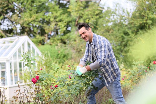 Team of gardeners practising safe procedures in a landscaped garden
